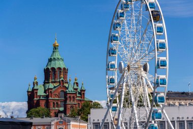 Cityscape with Eastern Orhodox Uspenski cathedral, Kauppatori in Etelasatama south harbour on July 8, 2024 in Helsinki, Finland. clipart