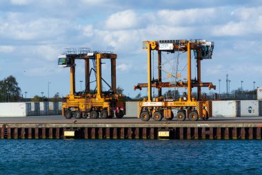 Loading cranes at CMP Copenhagem Malmo port on April 29, 2023 in Copenhagen, Denmark. clipart