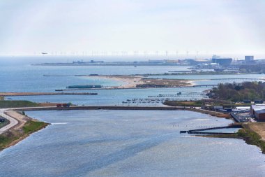 Copenhagen seacoast city skyline with Amager beach park, airport and wind farm in background, sunny spring day, Denmark clipart