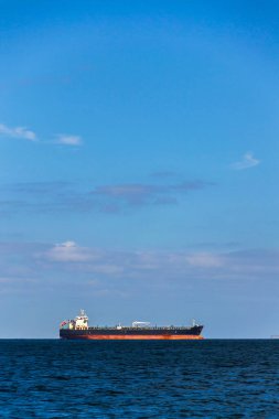 Oil tanker ship on sea with copy space on heaven and water, sunny day clipart