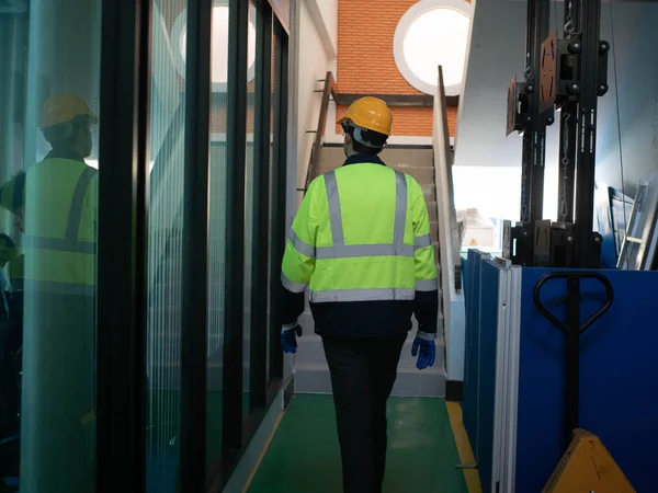 Backside person labor engineer staff yellow hardhat safety stand walk check up report factory forklift construction inspector industry company manufacturing  technician machinery control production