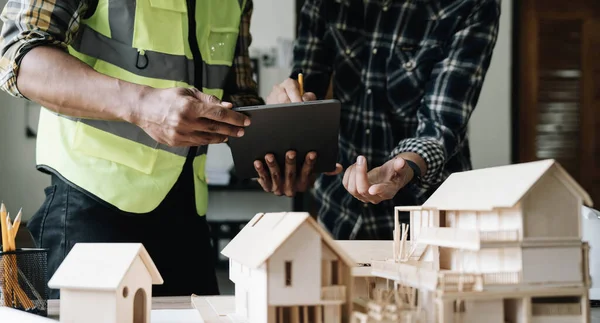 stock image Engineer Teamwork Meeting, Drawing working on blueprint meeting for project working with partner on model building and engineering tools in working site, Construction and structure concept..