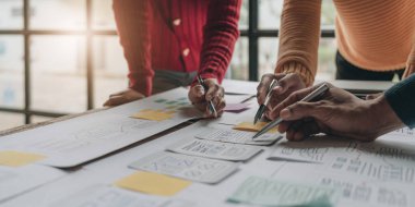 UI UX yaratıcı tasarım ekibi ofisteki ilgili cep telefonu uygulaması için kablosuz tasarım düzeni tasarlıyor.