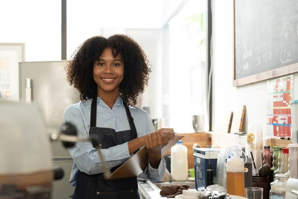 Successful Small Business Startup Small business owner SME Beauty Girl standing in front of a coffee shop with her arms crossed. Picture of an Asian female barista cafe owner...