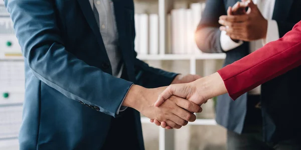 Business handshake for teamwork of business merger and acquisition,successful negotiate,hand shake,two businessman shake hand with partner to celebration partnership and business deal concept...