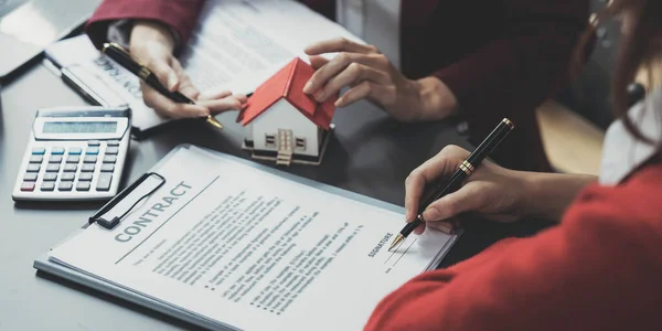 Real estate agent offer hand for customer sign agreement contract signature for buy or sell house. Real estate concept contact agreement concept..
