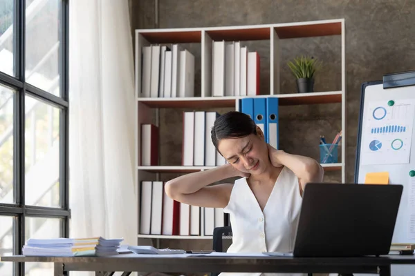 Young Business Asian women are stressed while working on laptop, Tired asian businesswoman with headache at office, feeling sick at work copy space in workplace an home office...