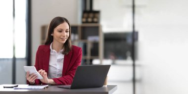 Business woman using calculator for do math finance on wooden desk in office and business working background, tax, accounting, statistics