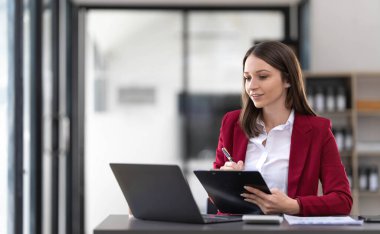 Business woman using calculator for do math finance on wooden desk in office and business working background, tax, accounting, statistics