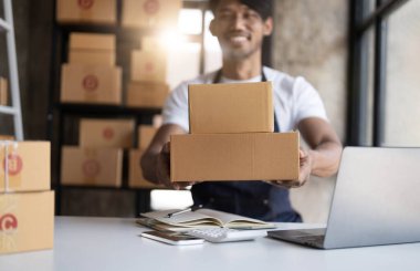 Start up entrepreneur of young asian man working with box for packaging order from shopping online in home for business online and online shopping...