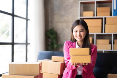Entrepreneur owner receive and checking online purchase shopping order to preparing pack product box. Selling online ideas concept. Startup small business..