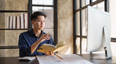 Mad crazy man employee sitting in office workplace with sticky notes all around, shouting furious angry, pissed off deadline and stressful job at office..