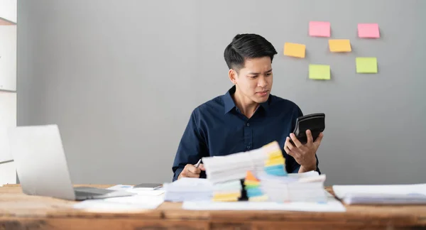 Mad crazy man employee sitting in office workplace with sticky notes all around, shouting furious angry, pissed off deadline and stressful job at office..