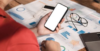 Business woman using phone for do math finance on wooden desk in office and business working background, tax, accounting, statistics and analytic research concept...
