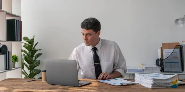 stock image Business accountant bookkeeper in office looking at documents and working with laptop...