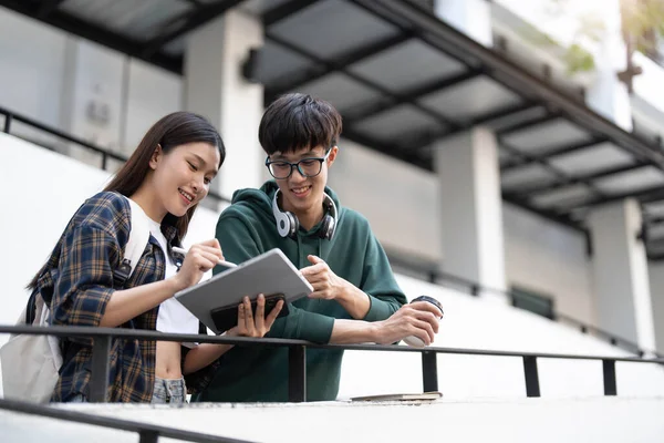 stock image Group of Asian college student reading books and tutoring special class for exam on grass field at outdoors. Happiness and Education learning concept. Back to school concept. Teen and people theme...