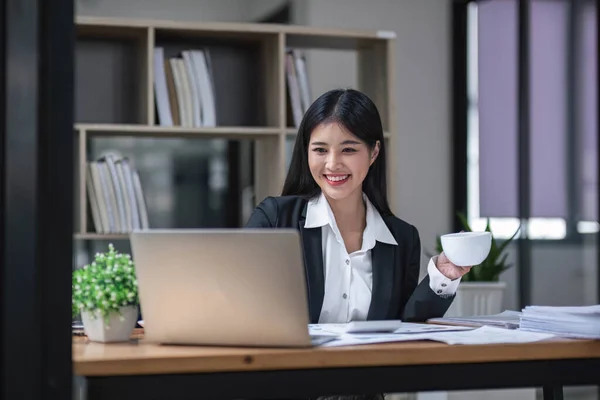 stock image Business woman using calculator for do math finance on wooden desk in office and business working background, tax, accounting, statistics and analytic research concept