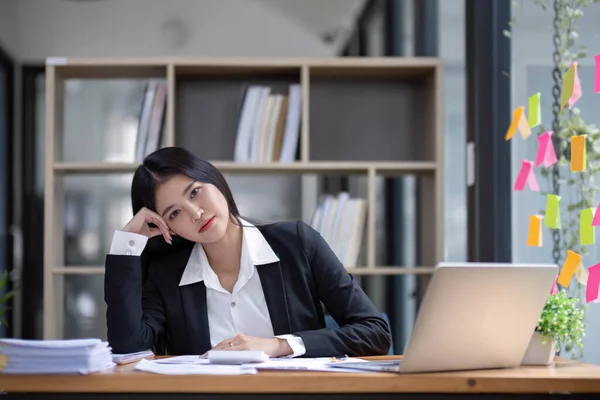 stock image Asian businesswoman are serious at work causing headache stressed out with documents with a laptop at the office...