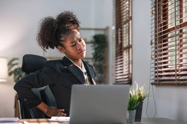 stock image tired business woman sleepy and bored from sitting at a desk for a long time and has office syndrome..