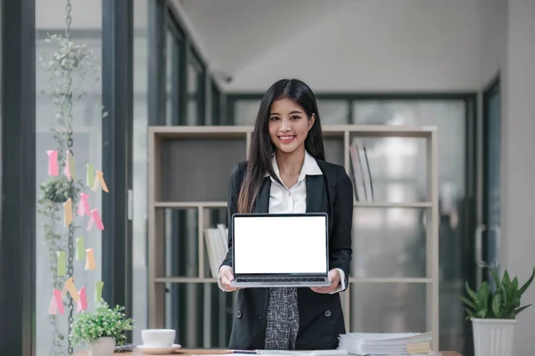 Business, finance and employment, female successful entrepreneurs concept. Talented real estate broker showing location to clients on laptop screen, having meeting with coworkers at office..