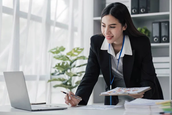 Business woman using calculator for do math finance on wooden desk in office and business working background, tax, accounting, statistics and analytic research concept....