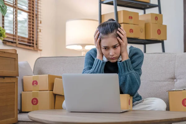 Young Asian woman entrepreneurs stress with finance problems after sales decline because of economic conditions ,COVID-19 outbreak. Face expression,emotion,reaction,failure in small-business concept