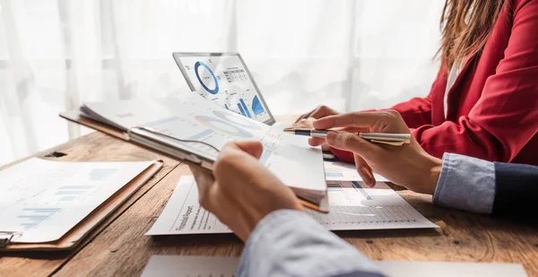 Stock image Business People Meeting using laptop computer,calculator,notebook,stock market chart paper for analysis Plans to improve quality next month. Conference Discussion Corporate Concept