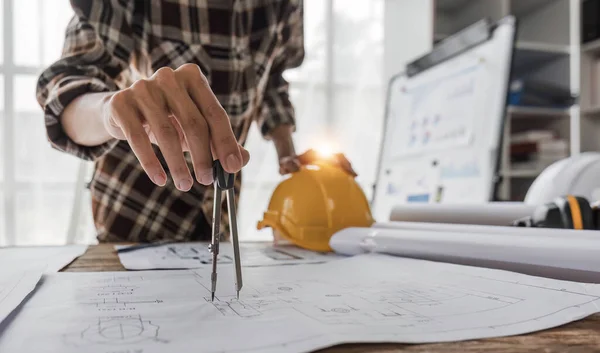 stock image Close up of civil male engineer asian working on blueprint architectural project at construction site at desk in office...