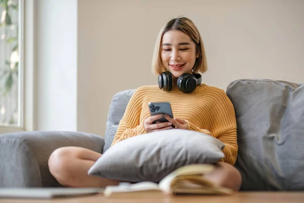 Happy Asian Woman Listening Music Mobile Phone While Sitting Rug — Fotografia de Stock