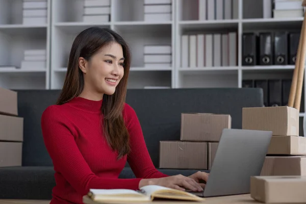 stock image Startup small business entrepreneur SME, asian woman packing cloth in box. Portrait young Asian small business owner home office, online sell marketing delivery, SME e-commerce telemarketing concept