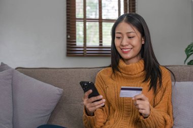 Ecommerce, hands or woman with credit card or phone for a digital payment on sofa relaxing at home. Smile, finance or happy girl online shopping for subscription sales offer, banking or fintech deal..