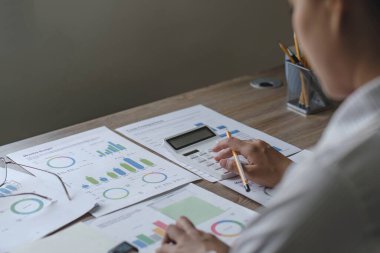 İş kadını, ofis ve iş geçmişinde, vergi, muhasebe, istatistik ve analitik araştırma kavramında matematik finansmanı için hesap makinesi kullanıyor....