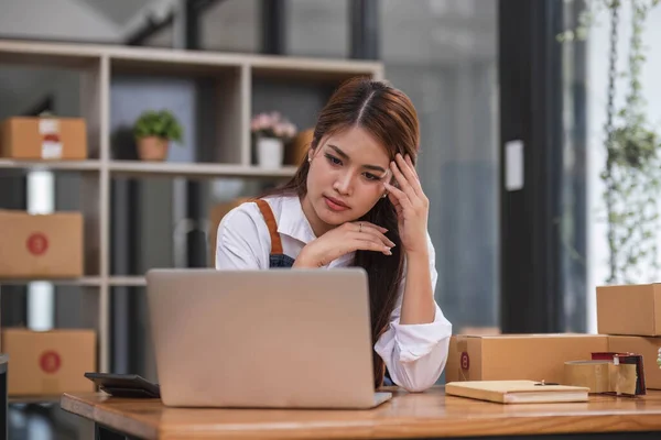 Small Business, Startup SME, Owner Entrepreneurs. Asian woman with unsuccess business online shopping crying and serious face unhappy mood...