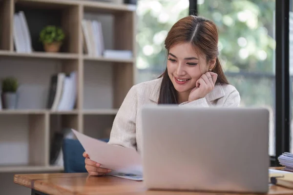 Business woman using calculator for do math finance on wooden desk in office and business working background, tax, accounting, statistics and analytic research concept.....