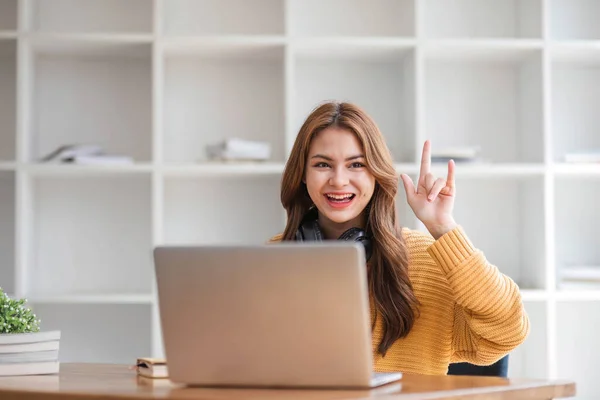 stock image Young women using laptop and listening song in on-ear headphones...