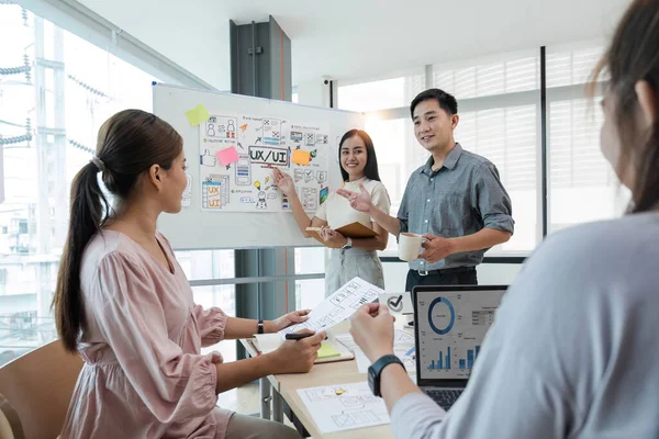 stock image Asian office team brainstorming, plan for solution idea, Group of asia creative teamwork and woman leader at business meeting for developing mobile phone app, ux, ui start up, small business.