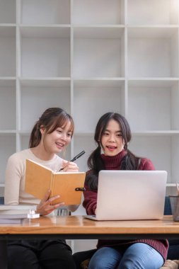 İki genç kız öğrenci birlikte ders çalışıyor..