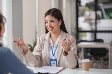 İki iş kadını grafikler ve finans verileri hakkında tartışıyor ve bilgi alışverişinde bulunuyor..