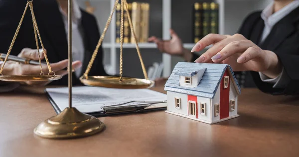 Real estate businessman consults a lawyer against the law relating to houses, land and real estate.