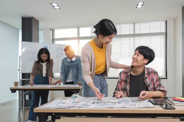 Toplantıda bir grup profesyonel Asya UI, UX grafik tasarımcısı veya geliştirici birlikte beyin fırtınası yapıyor ve yeni bir proje planlıyor....