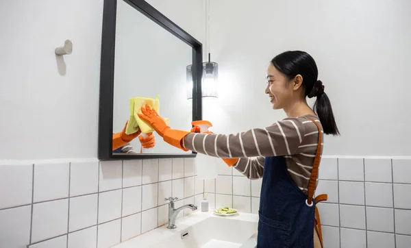 Genç Bir Hizmetçi Bez Temizlik Spreyi Kullanarak Banyoyu Temizliyor — Stok fotoğraf