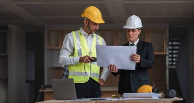 Diverse Team of Specialists Use Laptop on Construction Site. Real Estate Building Project with Engineer Investor and Businessman Checking Area, working on Civil Engineering, Discussing Strategy Plan.