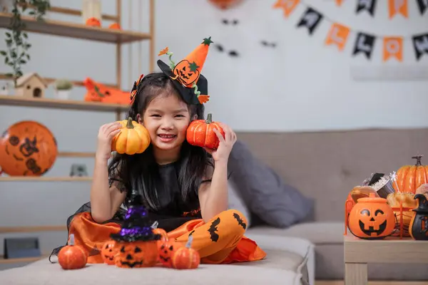 Cute Little Girl Wearing Halloween Costume Holding Pumpkin Home Happy Royalty Free Stock Photos