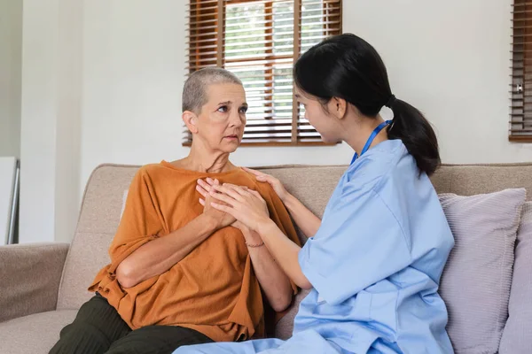 Health care elderly woman with nurse at home and on sofa in living room Support, encouragement, care and conversation with medical personnel to elderly or elderly women..