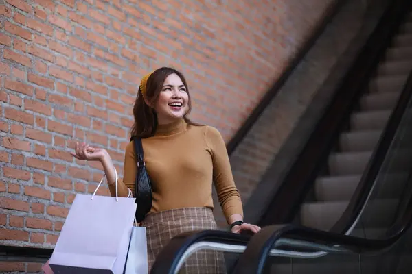 Beautiful Asian woman in shopping mall with shopping bags happy woman shopping.