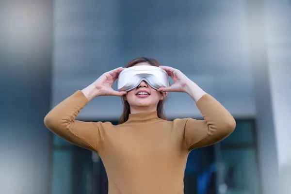 Beautiful Asian woman with virtual reality outdoors VR glasses equipment at the department store.