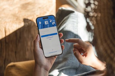 CHIANG MAI, THAILAND - 5 DEC 2023: Yeni giriş ekranlı facebook kullanmak için iPhone 14 'ü elinde tutan kadın. Facebook dünyanın en büyük sosyal ağı ve en popüler sosyal ağ sitesidir...