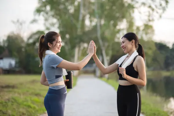 Beautiful Asian woman in sportswear is jogging or jogging in the park. To take care of your health and be strong.