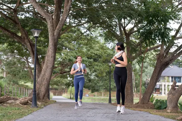 Beautiful Asian woman in sportswear is jogging together or jogging in the park. To take care of your health and be strong.