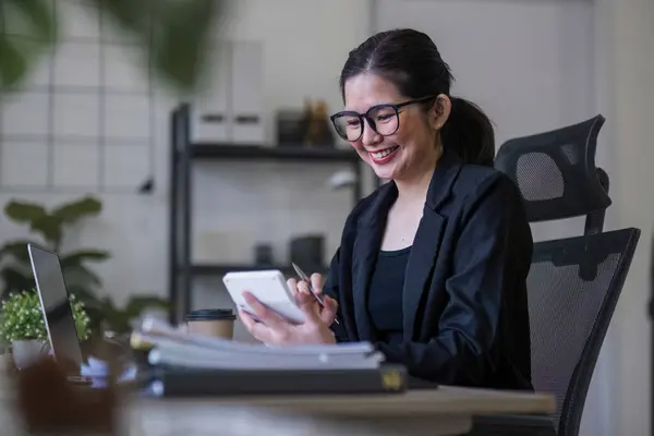 Business woman using calculator for do math finance on wooden desk in office and business working background, tax, accounting, statistics and analytic research concept.